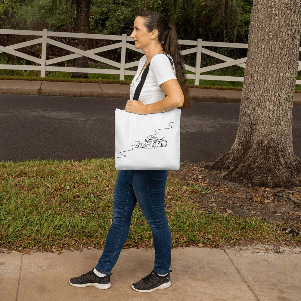 Fan inspired F1 merch tote back featuring black handles and illustrated track and race car