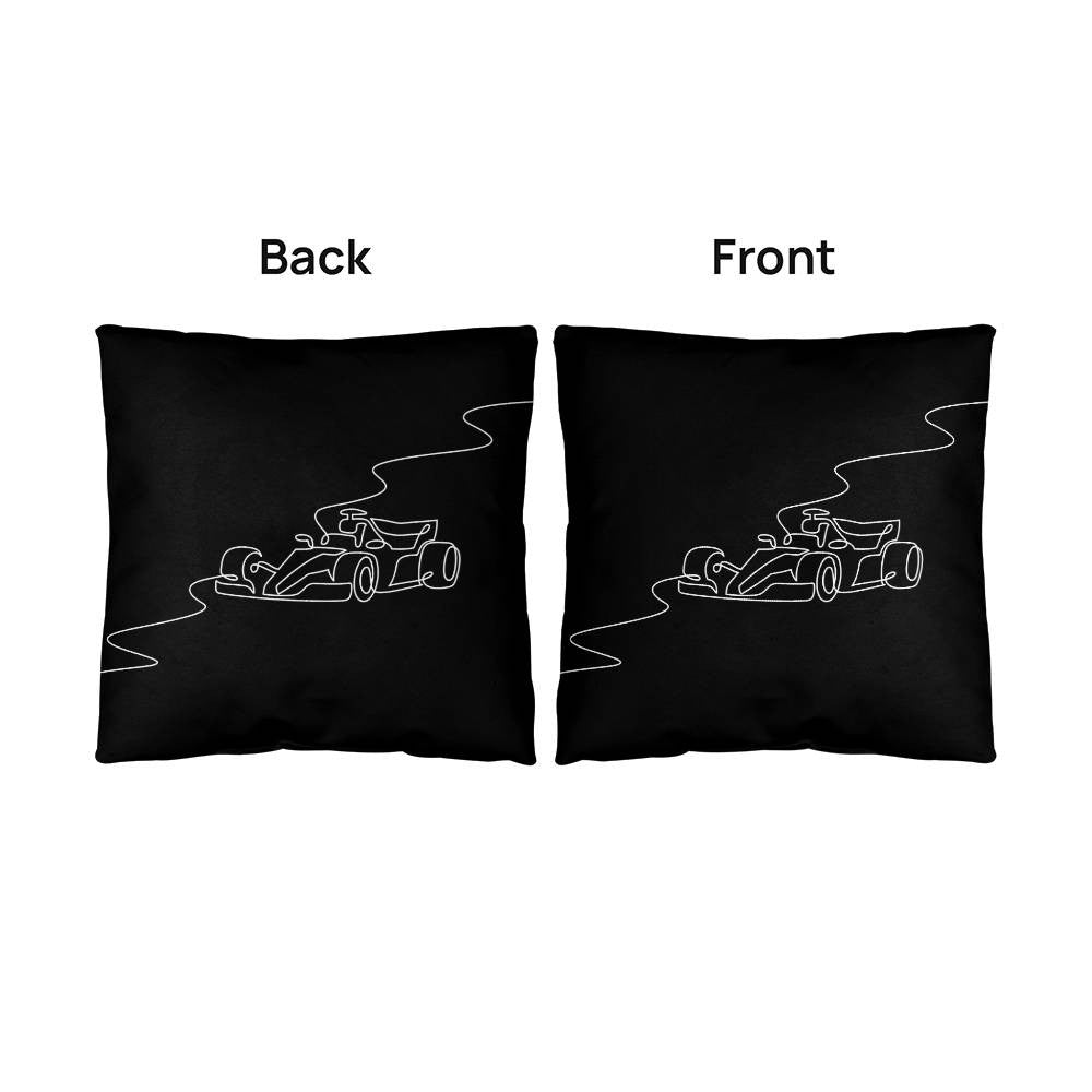 Front and back side by side images of F1 merch pillow in black with white illustrated race car