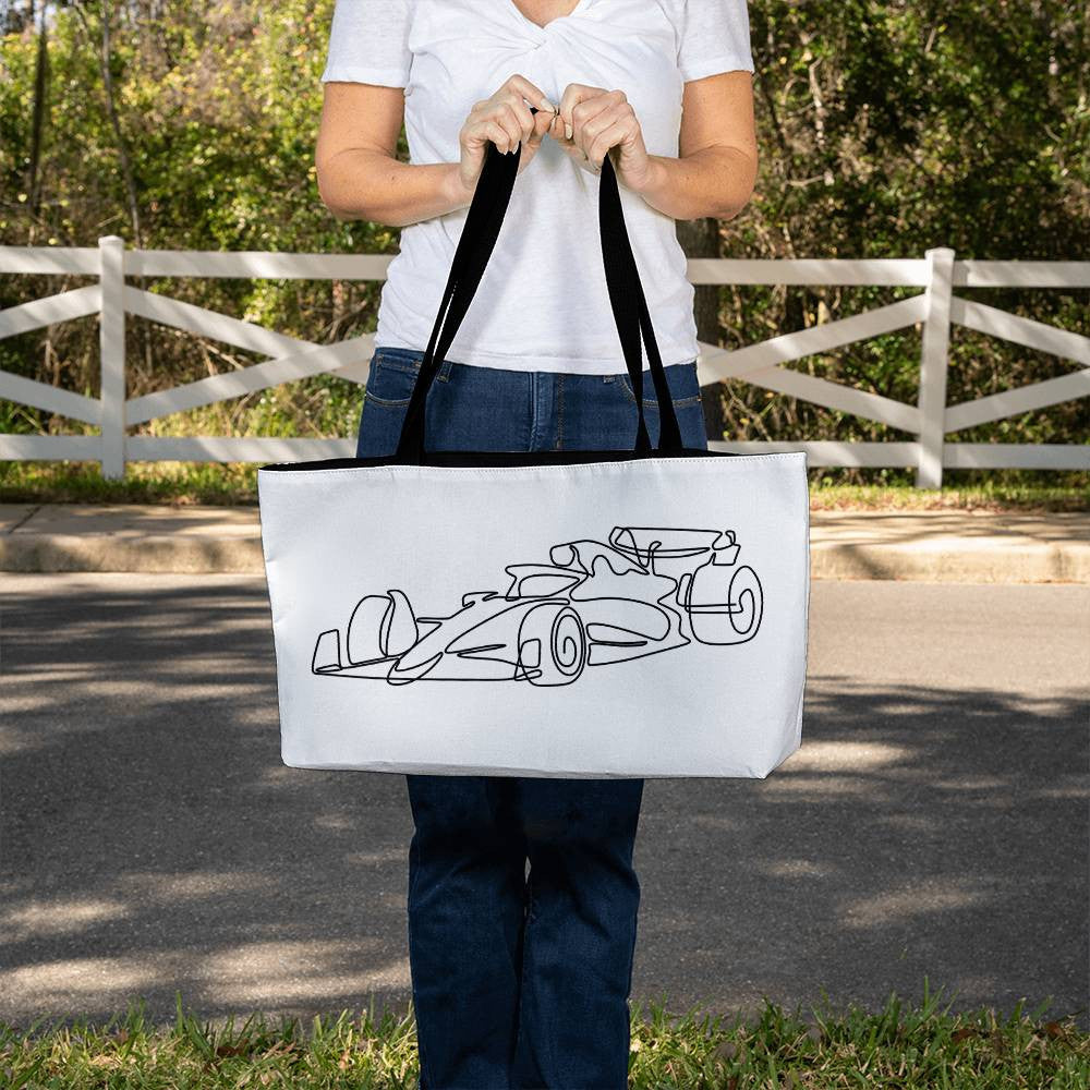 Person holding horizontal F1 white tote featuring black illustrated F1 race car