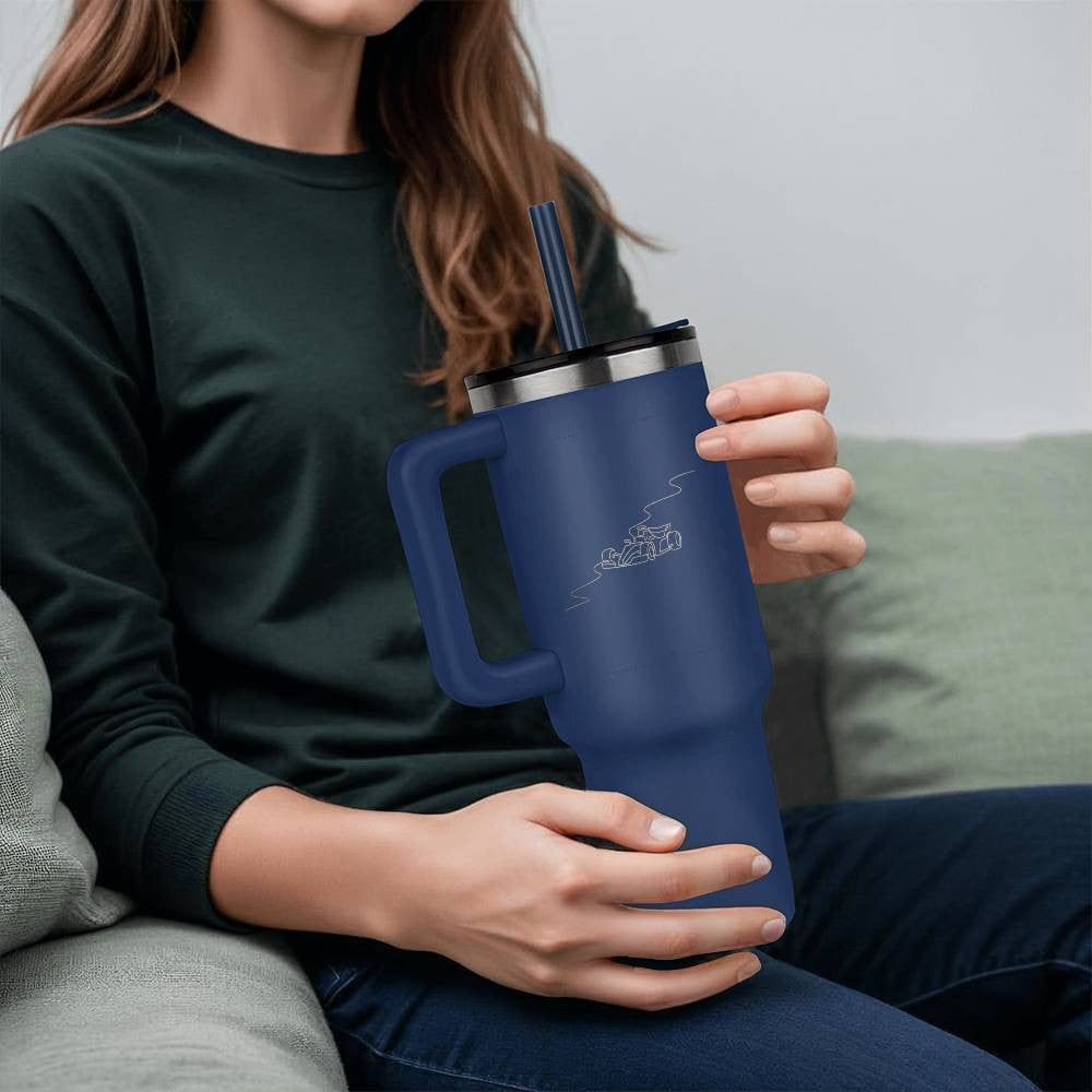 person holding a blue water bottle tumbler featuring illustrated track and race car