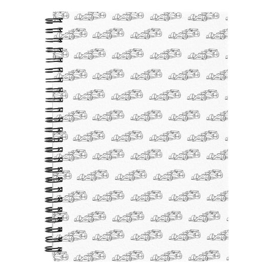 Close up of spiral F1 journal that's white with black F1 cars