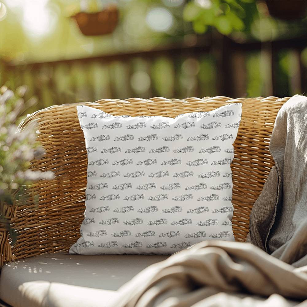 White pillow with black F1 cars sitting on outside chair