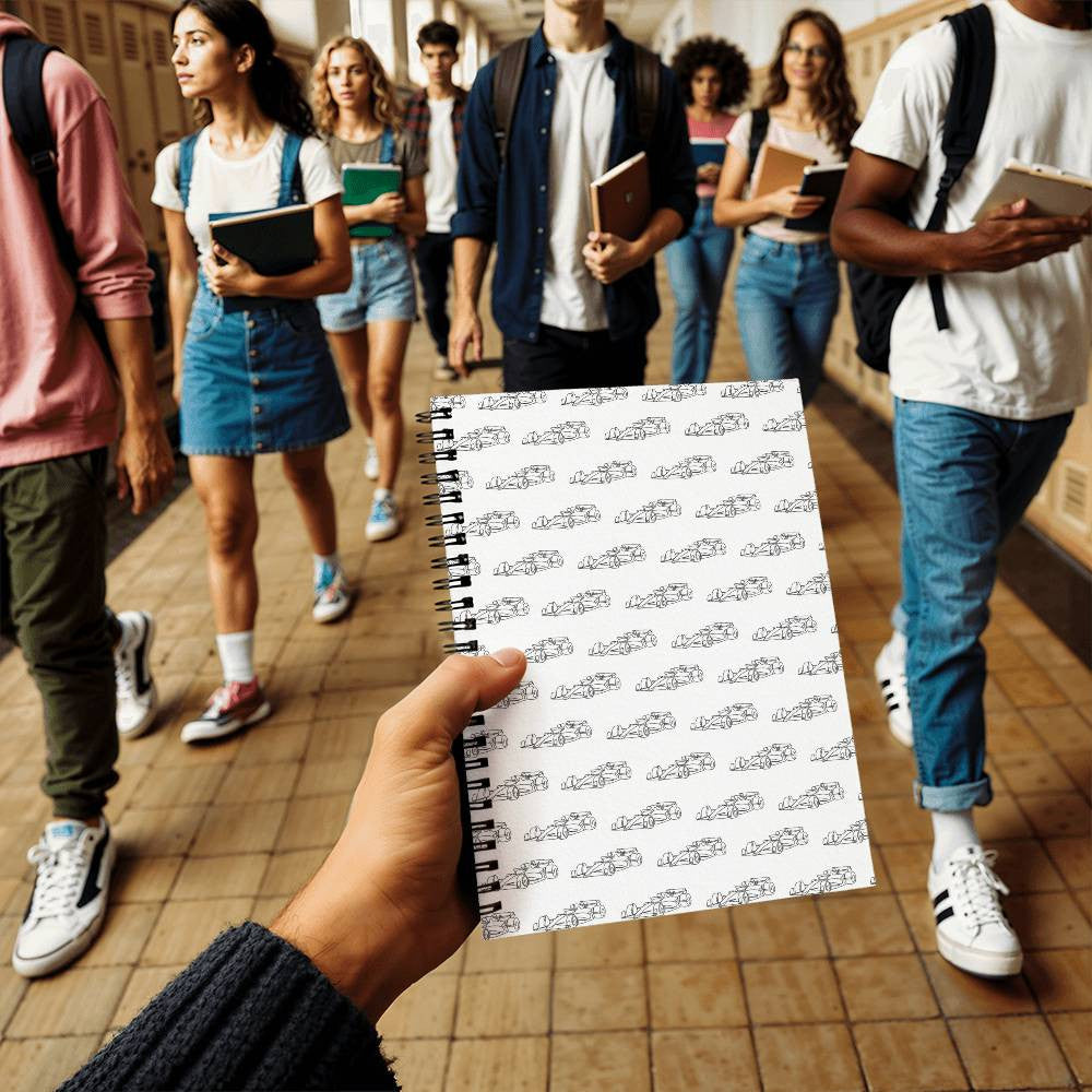 white with small black racing cars on the front of our F1 fan inspired spiral notebook